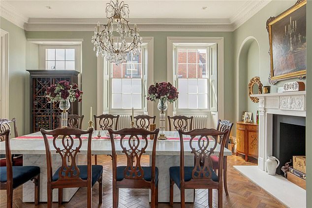 The end of terrace property has six bathrooms, a giant kitchen/breakfast room and a living area featuring a grand piano next to a spectacular Georgian fireplace