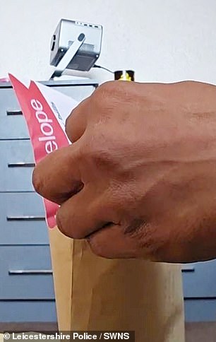 The video showed the 28-year-old crook packaging his ill-gotten gains into an envelope