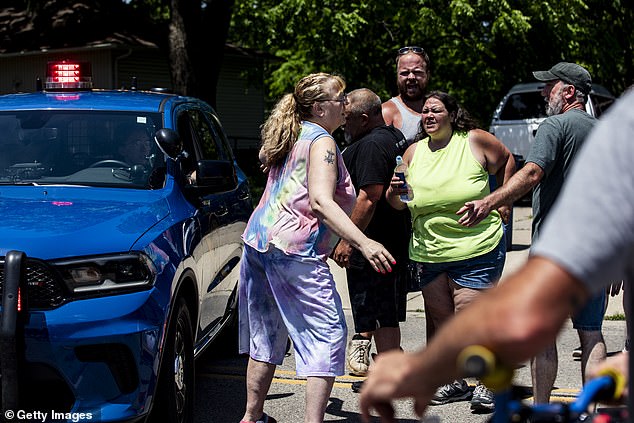 The chaotic scene unfolded during a service at CrossPointe Church. Community members are pictured gathering outside after the shocking sequence of events
