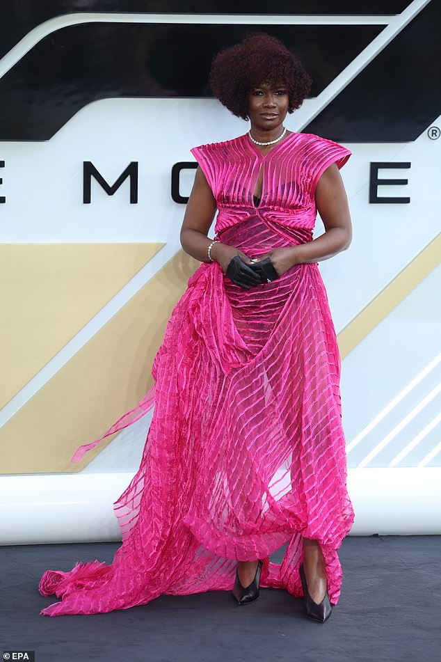 Actress Sarah Niles wowed in a striking bold fuchsia pink gown with a futuristic and sculptural design. The dress featured a structured, padded-shoulder bodice with a small front keyhole cutout