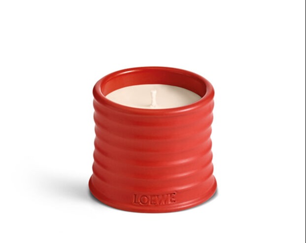 Red Loewe candle in a ribbed container.