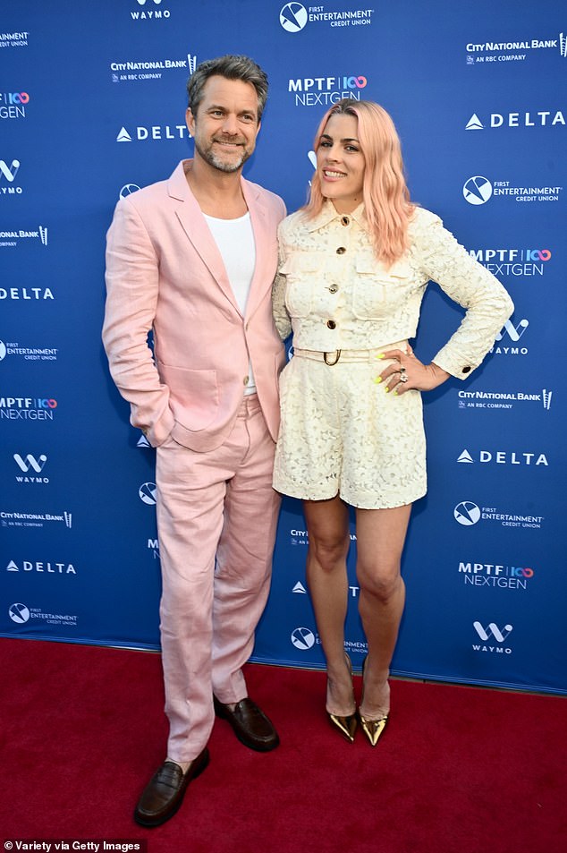 Philipps showcased her shapely legs wearing a lacy, white suit with shorts and a boxy jacket with gold buttons