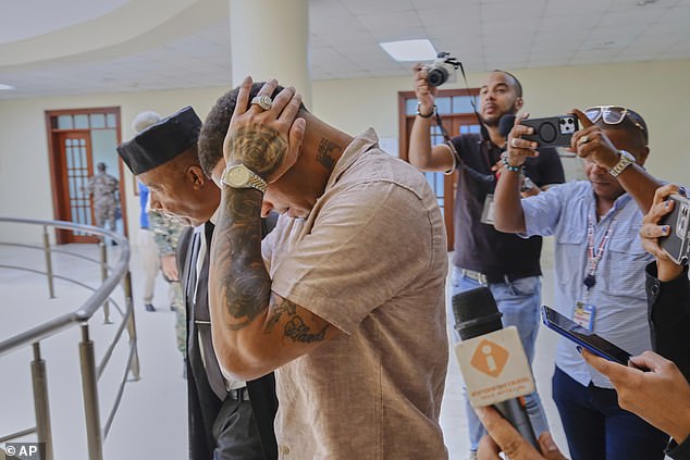 The baseball player covers his face as he arrived at court in Puerto Plata on Monday