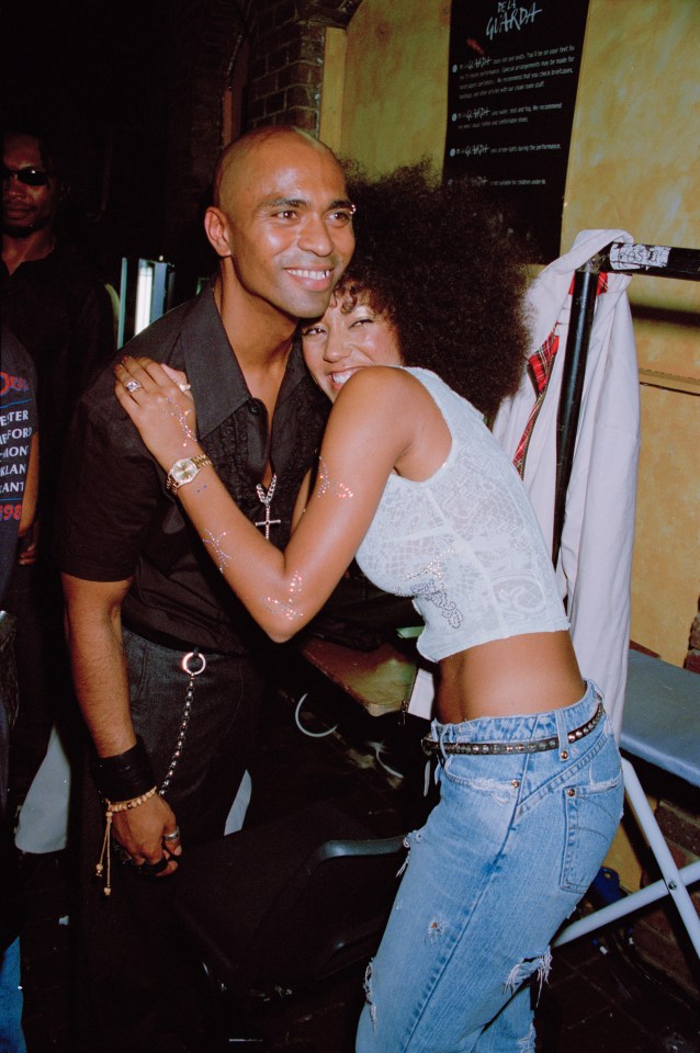 Mel B of the Spice Girls hugging her husband.