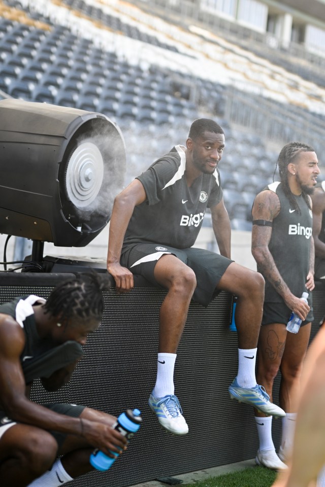 Chelsea soccer players cooling down with a fan after training.