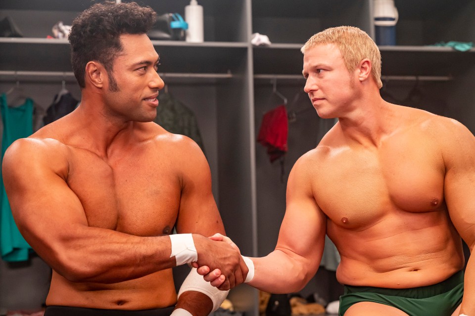 Uli Latukefu and Luke Hawx as Dwayne and Steve Austin shaking hands in a locker room.