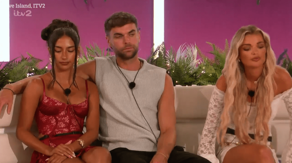 Three Love Island contestants sitting on a couch.
