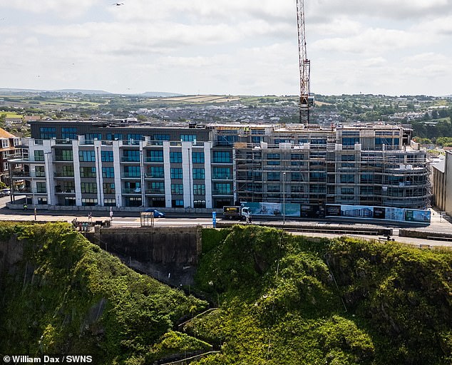 Residents of the cluster of luxury cliffside apartments were marketed 'high-end' coastal living spaces, offering a 'special and rare' opportunity