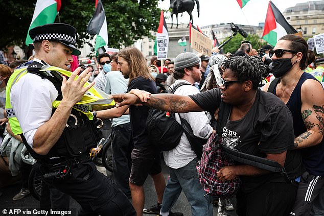 Protesters were seen scuffling with officers as they scrambled to get the demo under control
