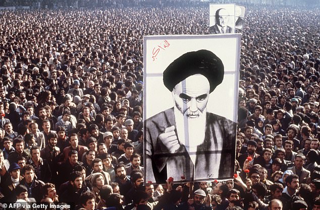 Demonstrators hold a poster of Ayatollah Ruhollah Khomeini, in January 1979, in Tehran, during a demonstration against the Shah