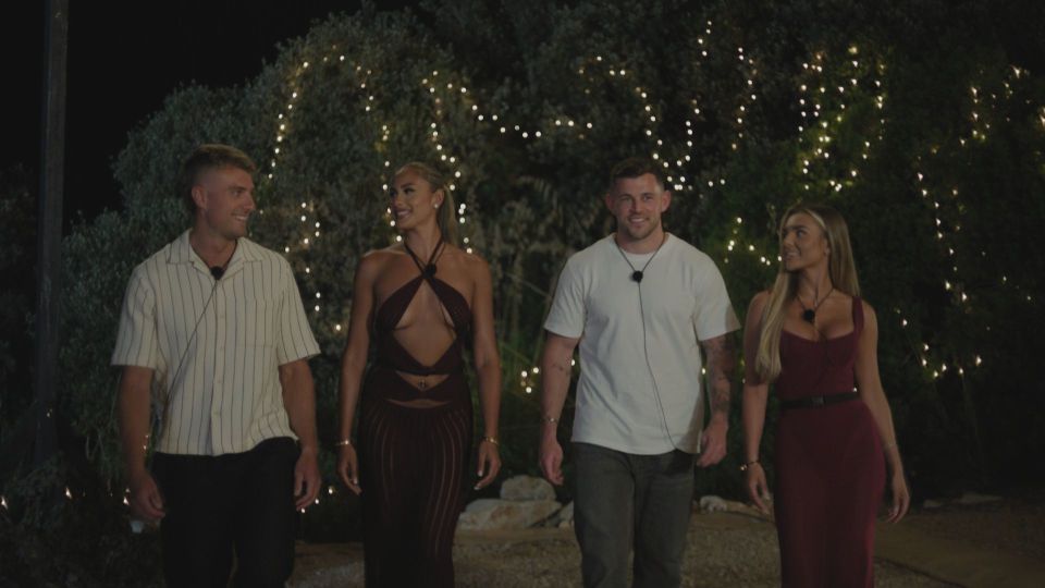 Four contestants from Love Island walking together at night.