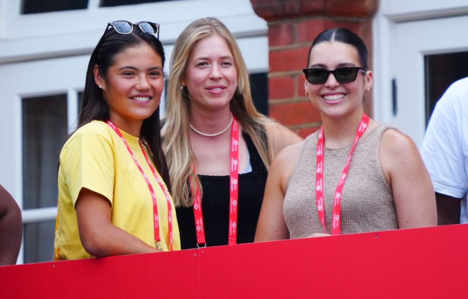 Emma Raducanu and two other women at a tennis match.