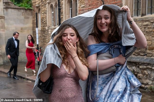 Two women blow kisses to the camera as they are snapped the morning after Trinity Ball still in their ballgowns