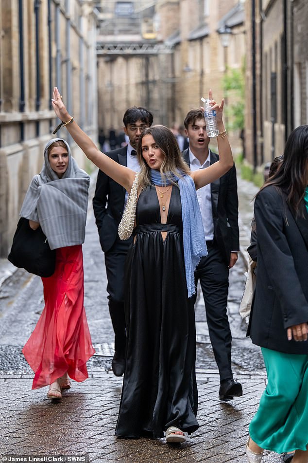 One woman - still in her evening dress - was pictured with a bottle of much-needed water