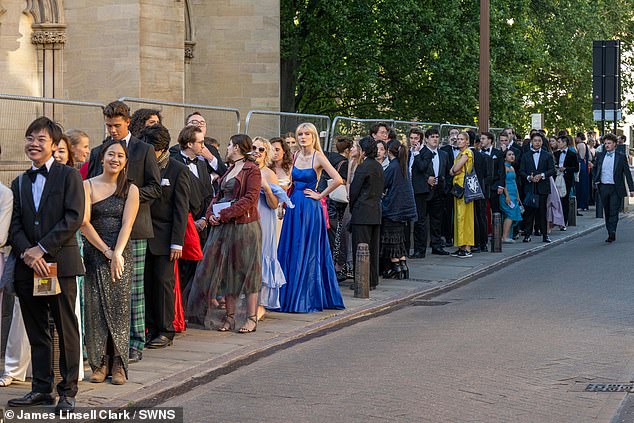 Hundreds of students are pictured queuing up to be let into the lavish Trinity Ball yesterday evening