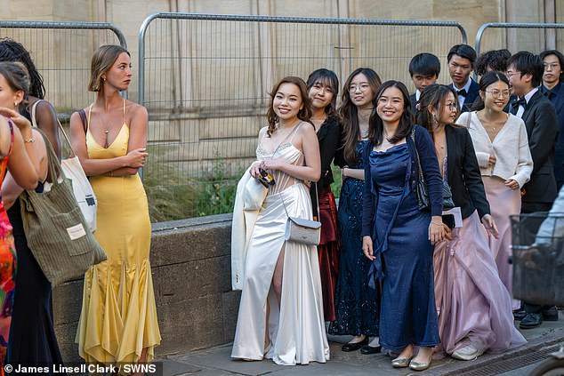 Groups of students arrived during a perfect summer's evening to Cambridge's Trinity College