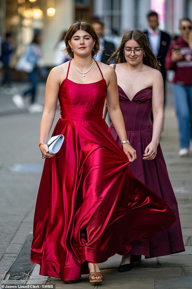 Those who organised Trinity Ball said they are enforcing a strict 'black-tie minimum' dress code, as two students are snapped in their best frocks