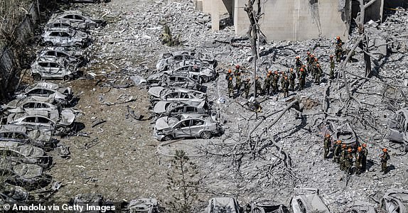 BEERSHEBA, ISRAEL - JUNE 24: Search and rescue efforts continue in the seven-story building that was partially collapsed and hit by a ballistic missile fired from Iran shortly before the ceasefire announced by US President Donald Trump came into effect in Beersheba, Israel on June 24, 2025. There were reported deaths and injuries in the attack. A ceasefire between Israel and Iran came into effect at 0400GMT Tuesday following hours of intensified mutual hostilities. (Photo by Mostafa Alkharouf/Anadolu via Getty Images)