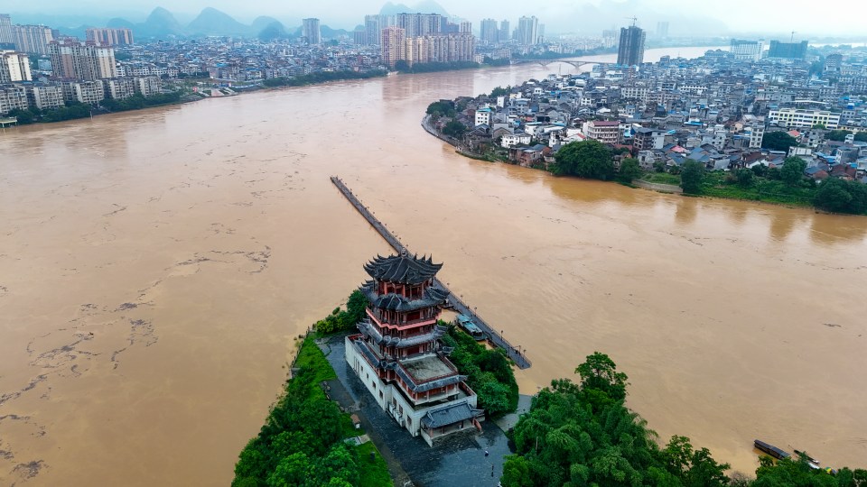 Aerial view of flooded Rongjiang River in Rong'an County, China, showing a pagoda on an island.