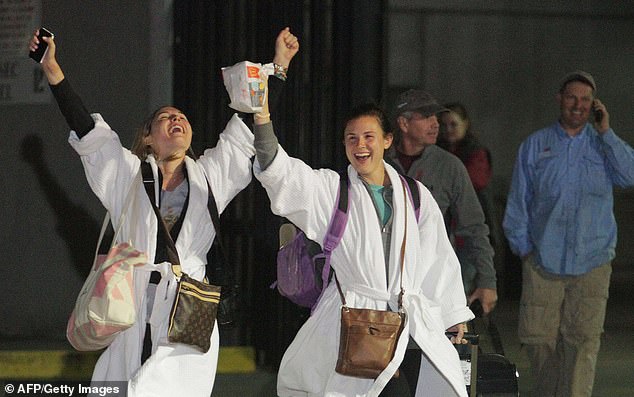 Relieved passengers (pictured) finally escaped the 'poop cruise' after it was towed into port in Mobile