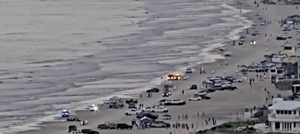 Aerial view of emergency responders on New Smyrna Beach after a lightning strike.