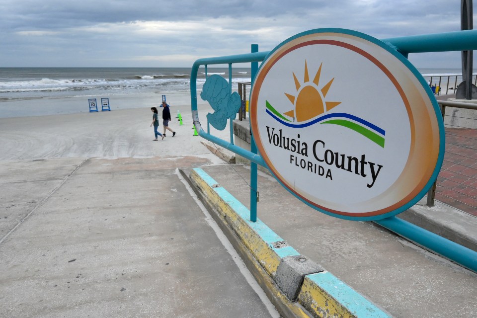 Volusia County, Florida beach access ramp with people walking.