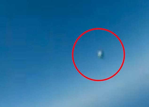 One clip was taken from a Navy cockpit in a training area and shows a spherical object floating by the aircraft