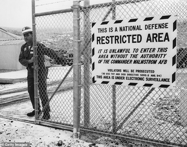 Dec. 29, 1962: A guard closing the gate to entrance of the control center of the missile base at Malmstrom, Montana, where the ballistic missile 'Minuteman' is kept