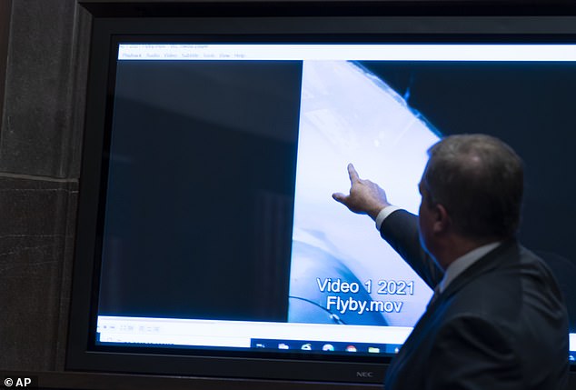 Deputy Director of Naval Intelligence Scott Bray points to a video display of a UAP during the hearing