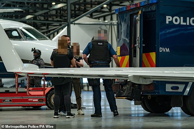 Police marksmen watched on as Harding was loaded into a van