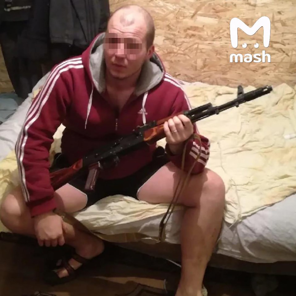 A Belarusian tourist holding an assault rifle.