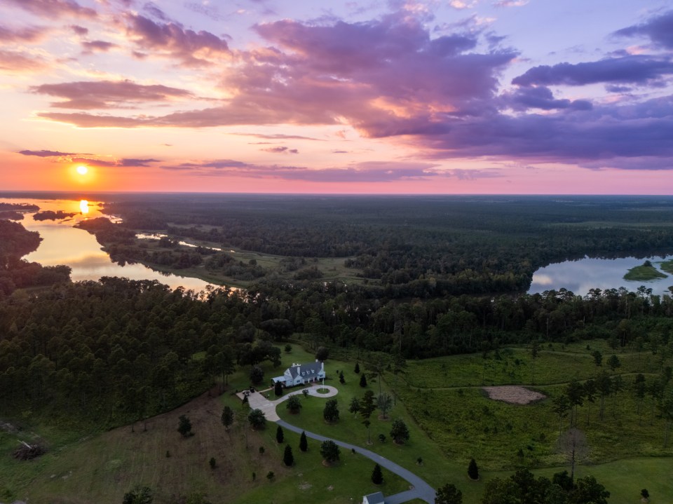 Aerial view of a large ranch at sunset.