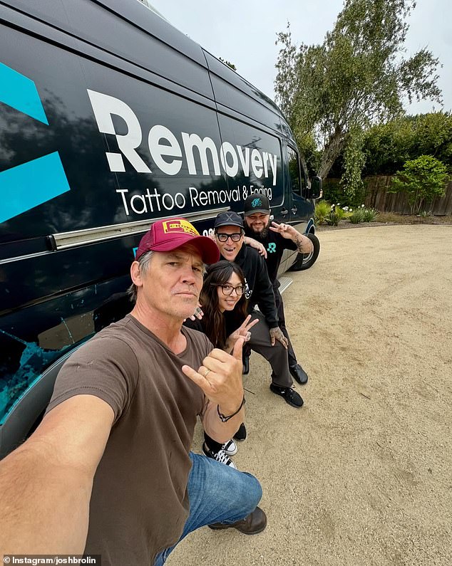 He posed in a photo in front of a black van with the business name 'Removery Tattoo Removal & Fading' across it