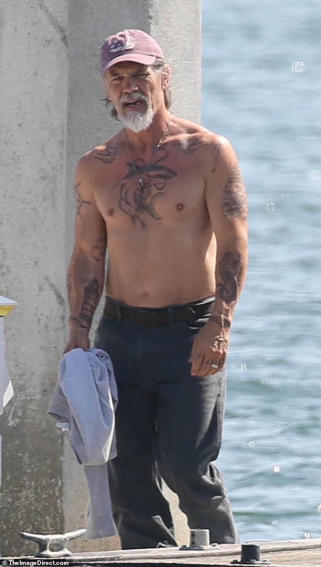 His chest, arms, and back were heavily inked, more than one year after the star removed a real tattoo on his shoulder blade