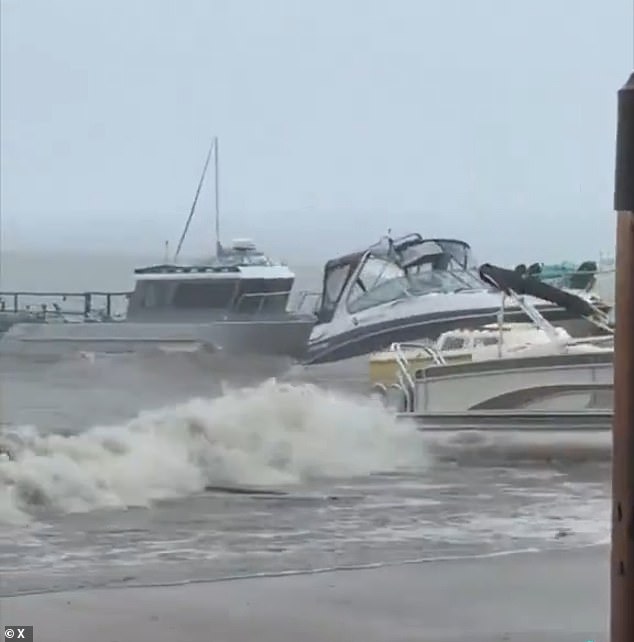 Terrifying video footage from the storm showed dozens of boats battling the fierce, churning waters - crashing into each other as they struggled to withstand the intense power of the waves (pictured)