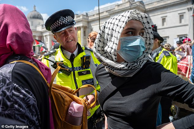 Protesters, some wearing black face coverings or Palestinian keffiyehs, were seen at the event