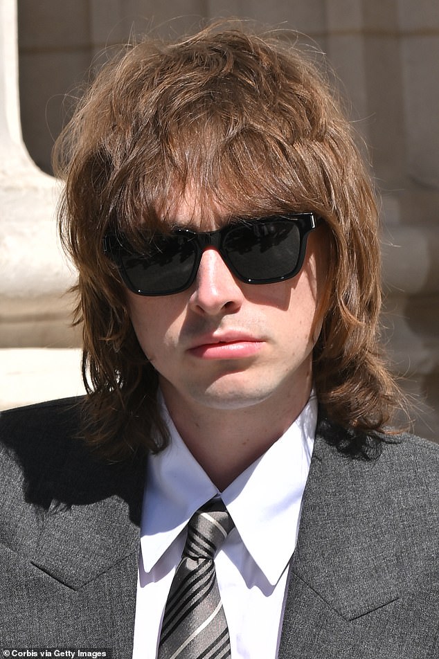 Gene also added black shades as his locks just touched his shoulders