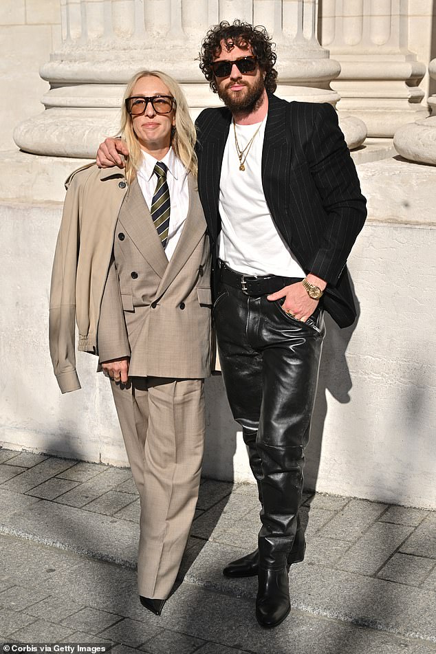 Sam Taylor-Johnson opted for an oversized taupe suit and jacket as she posed with her husband Aaron Taylor-Johnson