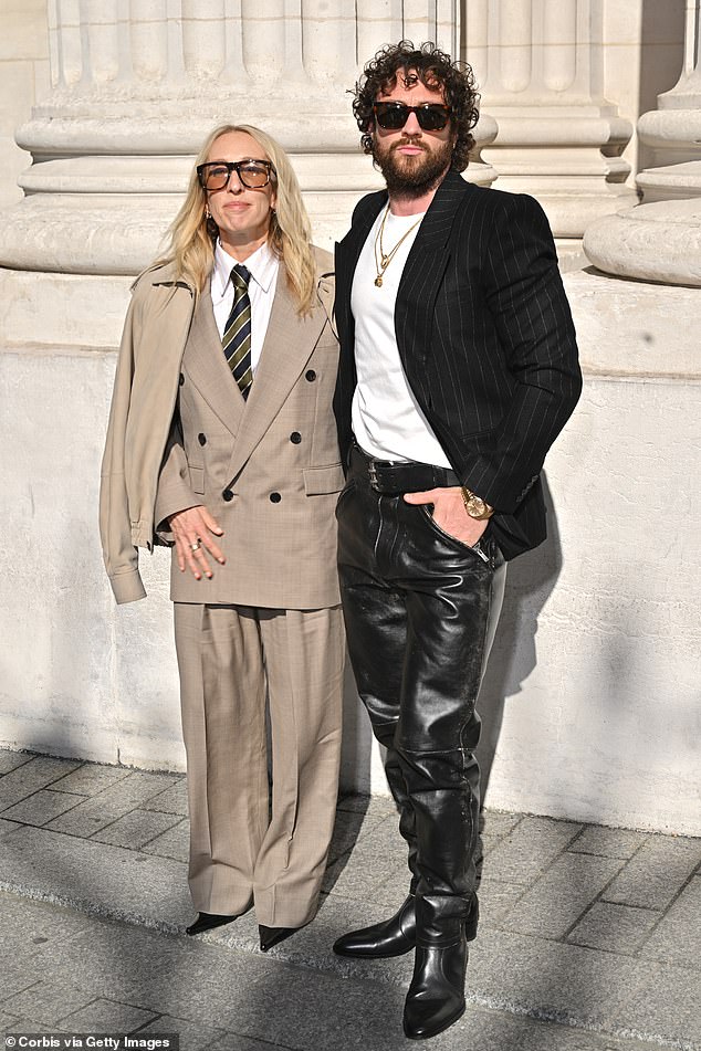 Aaron, 35, wowed in a pair of leather black trousers and boots which he paired with a black pinstripe blazer and white T-shirt