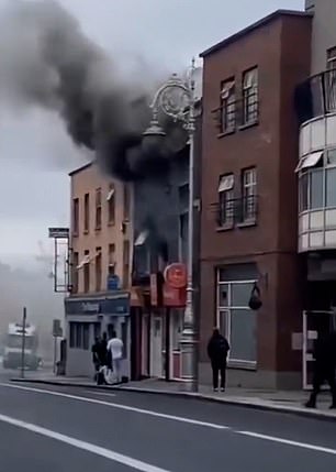 This is the heartstopping moment a hero lorry driver reversed his truck near a burning building to save a man.