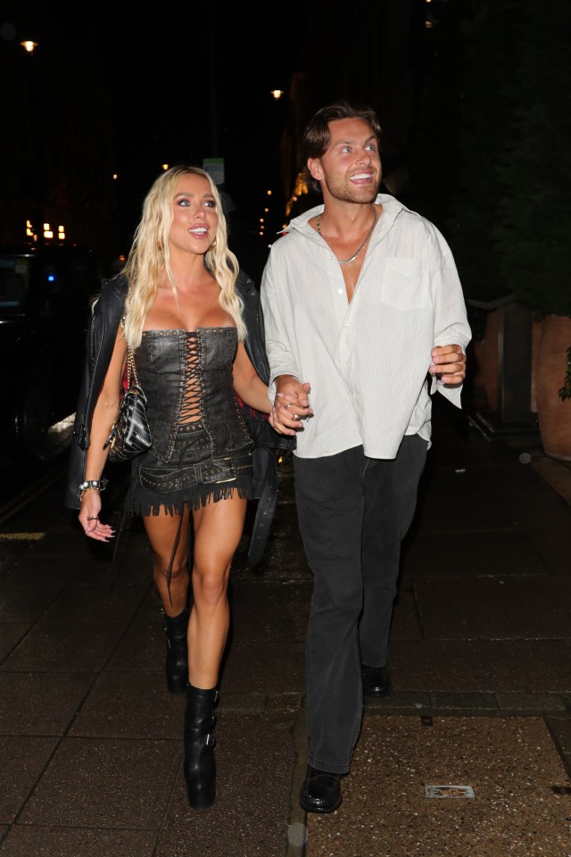 Gabby Allen and Casey O'Gorman holding hands walking at night.