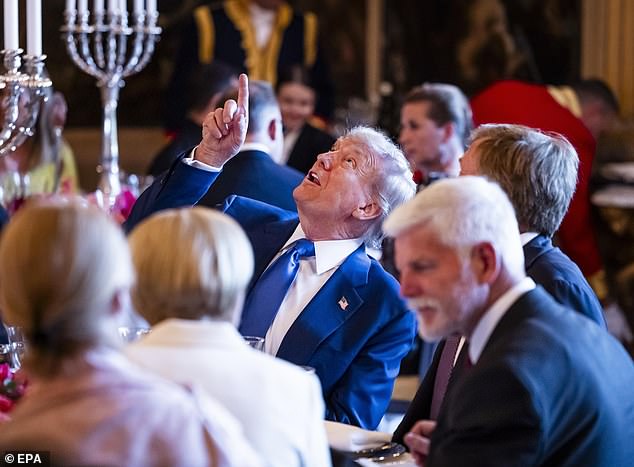 Trump and King Willen-Alexander look up and chat while at a dinner with heads of state and government