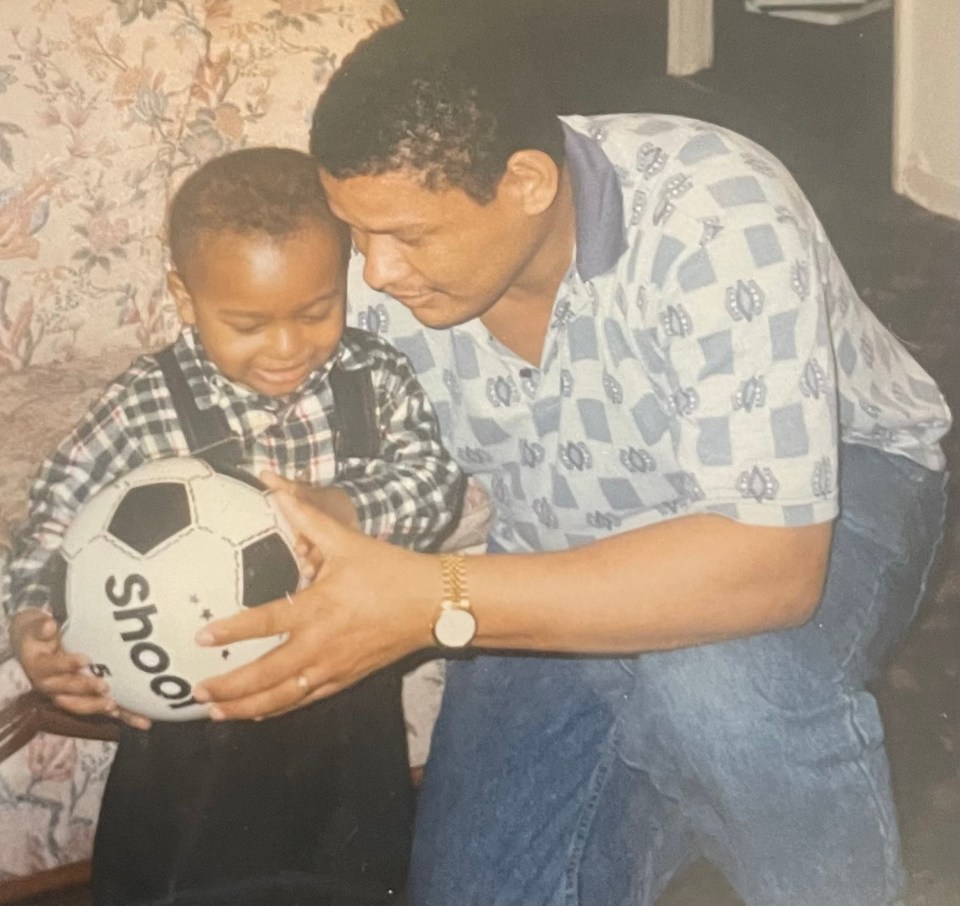 Alex Iwobi as a young child with his father, holding a soccer ball.