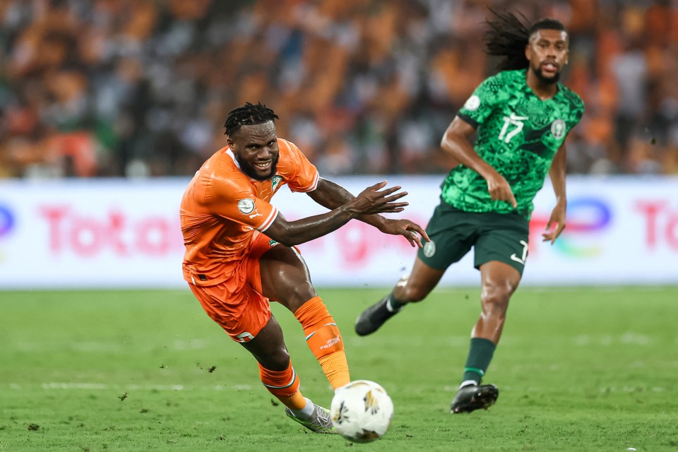 Franck Kessie (Ivory Coast) and Alex Iwobi (Nigeria) fight for the ball during a soccer match.