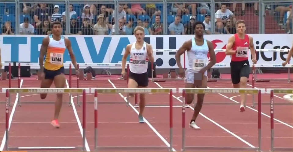 Four hurdle racers competing in a track and field event.
