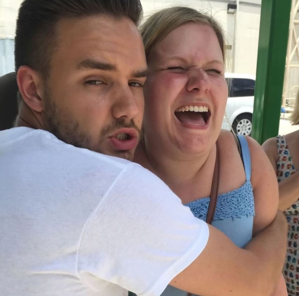 Liam Payne hugging a laughing fan.