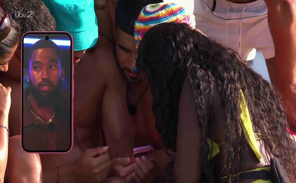 Islanders watching a video on a phone.