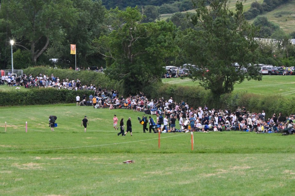 Festival-goers waiting in line to enter Glastonbury Festival.