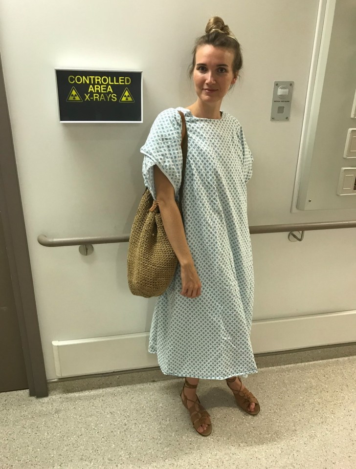 Woman in hospital gown awaiting X-ray.