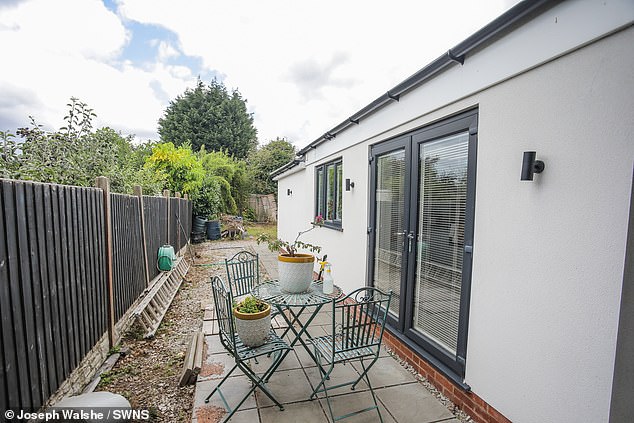 The white-washed bungalow features its own gravel drive and patio seating area. Its water and electrics are connected to the main house, a three-bedroom property worth around £355,000